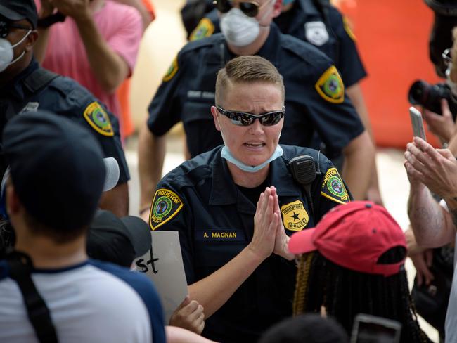 Police officers try to calm down the crowd after a physical altercation that broke out in the crowd during a demonstration over the death of George Floyd, in Houston, Texas. Picture: AFP