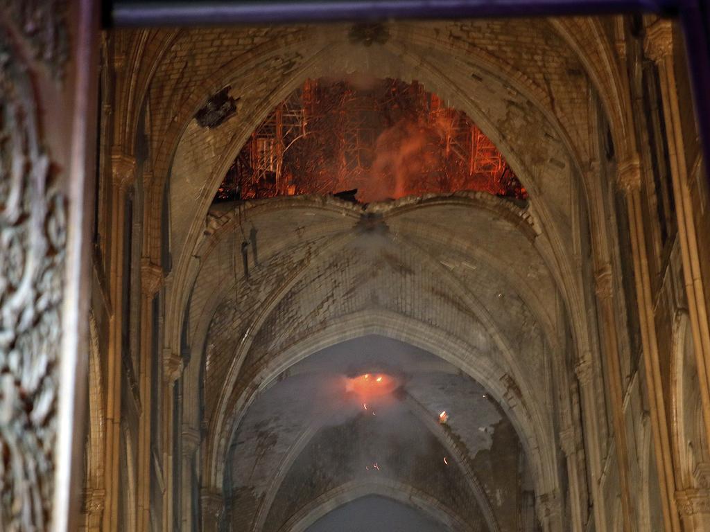 Flames and smoke are seen in the interior of the cathedral. Picture: Philippe Wojazer/AP