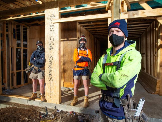 The building and construction industry scrambles to figure how to work under new stage four lockdown rules. Builders Daniel Billing (yellow), Zak Whitnell (orange) and Tyler Brindle (blue) on site. Picture: Mark Stewart