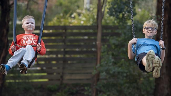 Harrison and Miller swing around at their local park in Warranwood. Picture: Andy Brownbill