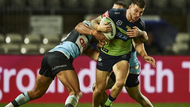 SYDNEY, AUSTRALIA - MARCH 21: Curtis Scott of the Raiders is tackled during the round two NRL match between the Cronulla Sharks and the Canberra Raiders at Netstrata Jubilee Stadium, on March 21, 2021, in Sydney, Australia. (Photo by Brett Hemmings/Getty Images)