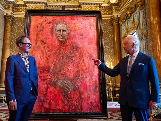 Artist Jonathan Yeo and King Charles III stand in front of the portrait of the King Charles III, which has since been vandalised in the gallery where it hangs. Picture: Getty Images