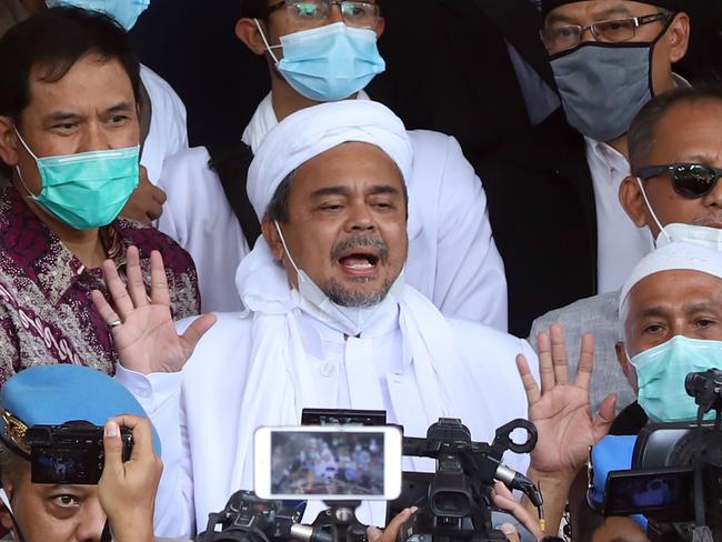 Rizieq Shihab, centre, surrounded by his supporters at the police headquarters in Jakarta, before his arrest on Sunday. Picture: AFP