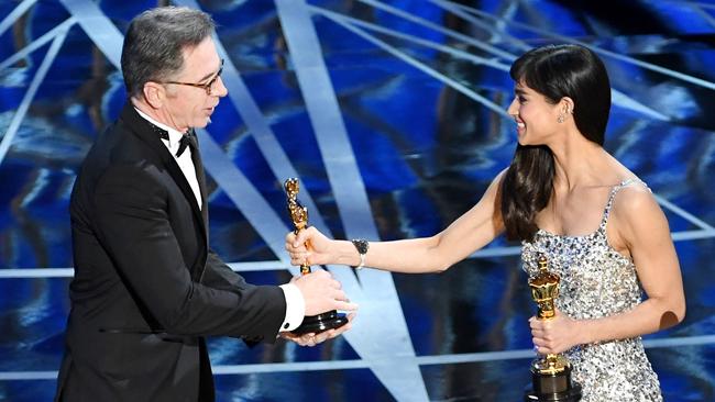 Kevin O'Connell accepts the Oscar from actor Sofia Boutella. Picture: Getty