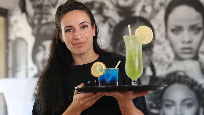 Jess Yasemi serves up a Purple Dragon and a Green Lantern cocktail at RnB bar and lounge Kingz and Queenz, which opened in July. Picture: Brendan Radke