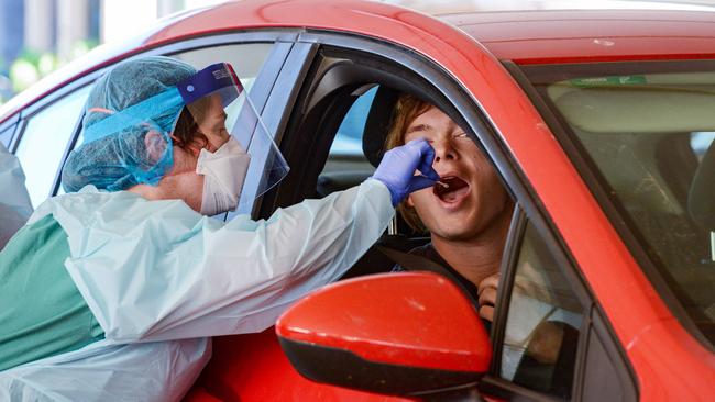 The first patient to use the new drive-through coronavirus test station is checked by a nurse at the Repatriation Hospital in Daw Park, Adelaide. Picture: AAP