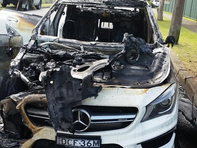 The burnt out white Mercedes getaway car used in a shooting in Bankstown. Picture: Channel 7