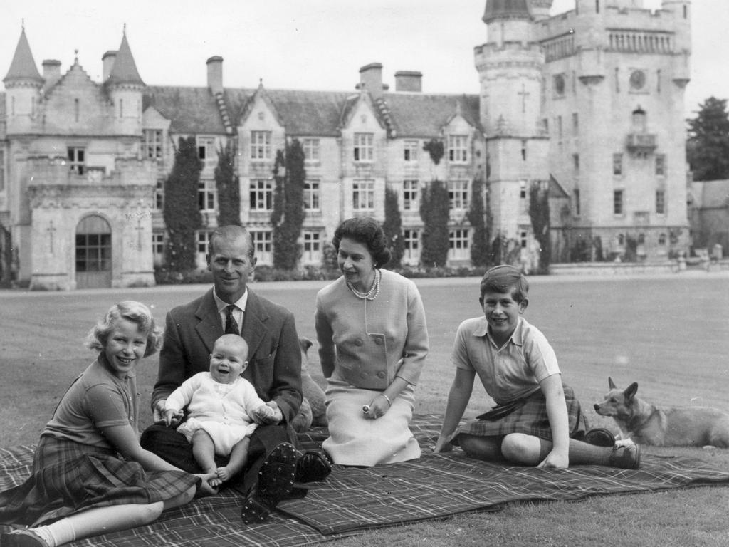 9th September 1960: Queen Elizabeth II and Prince Philip, Duke of Edinburgh with their children, Prince Andrew (centre), Princess Anne (left) and Charles, Prince of Wales sitting on a picnic rug outside Balmoral Castle in Scotland. Picture: Keystone/Getty Images