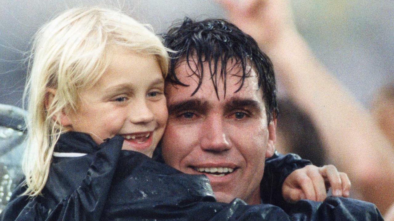 Footballer Greg Phillips with tears in his eyes hugging with daughter Erin Phillips after match. SANFL football - Glenelg vs Port Adelaide grand final match at Football Park. Used 04 Oct 1992. (Pic by staff photographer Neon Martin)