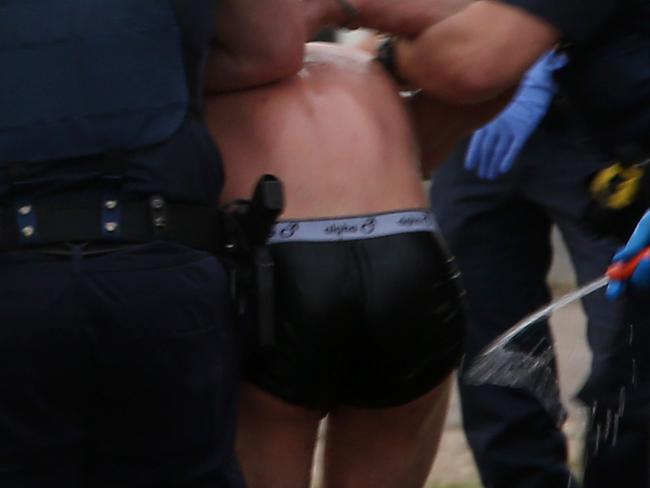 A man being arrested in his underwear in Svendsen St, Westcourt. PICTURE: STEWART McLEAN