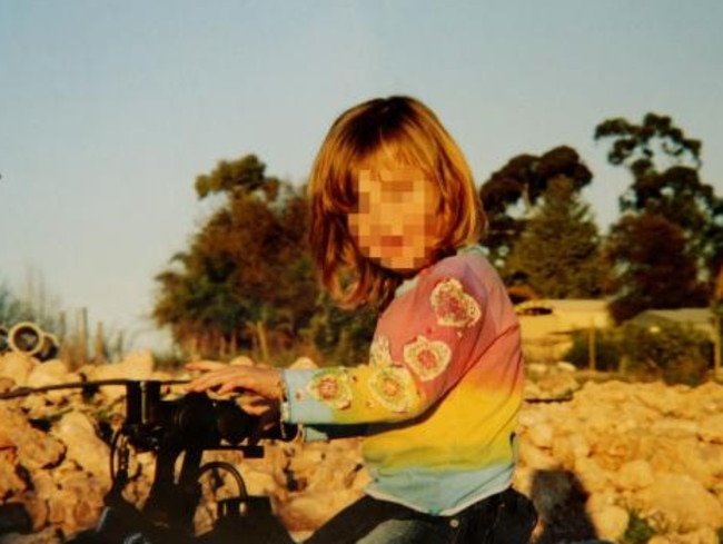 One of the Colt family children on the farm at Boorowa, NSW before a convoy of police and child workers arrived on the scene. Picture: News Corp.