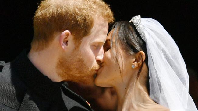 Prince Harry and Meghan Markle kiss after their wedding, a few hours before the party at Frogmore House. Picture: Ben Birchall/WPA/MEGA