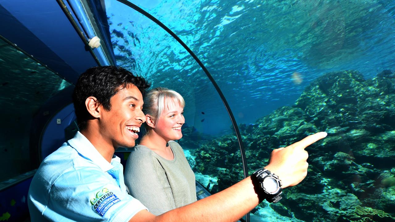 Reef HQ Reef guide Ryan Ramasamy shows American tourist Stephanie Rains through the aquarium. Picture: Zak Simmonds