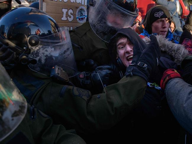 Canadian police began a massive operation to clear the trucker-led protests against Covid health rules clogging the capital for three weeks, with several arrests made. Picture: AFP