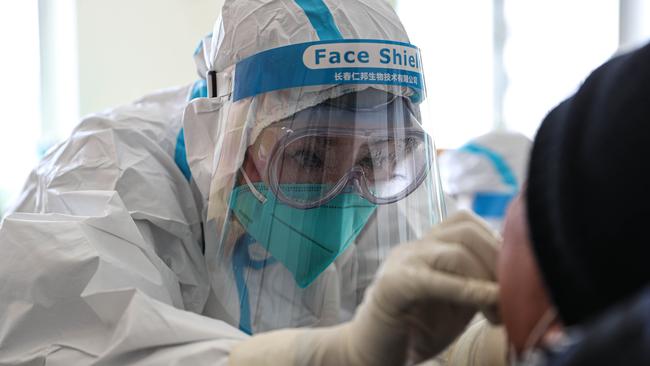 A medical worker takes a swab sample from a resident to test for the COVID-19 coronavirus in Shenyang, in China's northeast Liaoning province. Picture: AFP