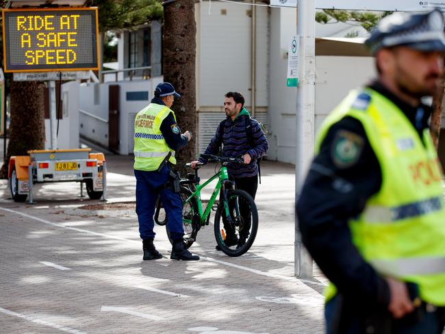 SYDNEY, AUSTRALIA - NewsWire Photos MAY 17, 2023: Police stop bike riders on Manly Beach on Tuesday. Picture: NCA NewsWire / Nikki Short