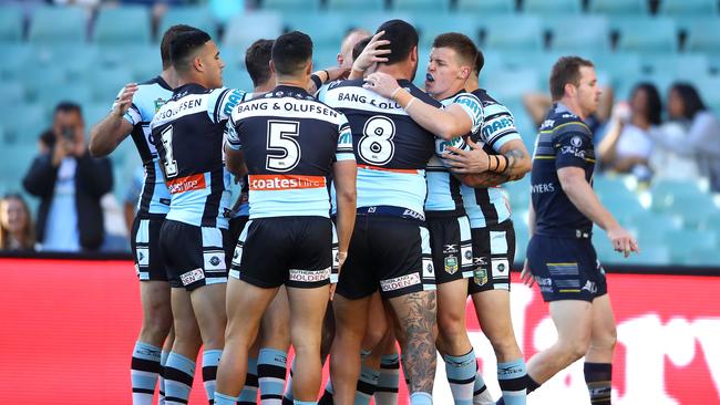 The Sharks celebrate Chad Townsend’s opening try of the match.