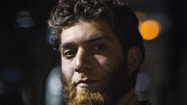 A man strokes his beard while Muslims gathered in at Lakemba Rail Station to rally after a series of police raids against a terror plot. Photos: Chris McKeen