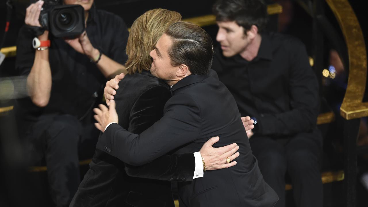 Brad Pitt (left) is congratulated by Leonardo DiCaprio at the Oscars. Picture: AP Photo/Chris Pizzello