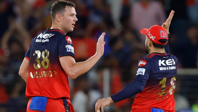 Josh Hazlewood of Royal Challengers Bengaluru celebrates with teammate Virat Kohli after dismissing Priyansh Arya of Punjab Kings during the 2025 IPL Final.