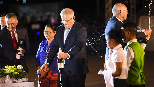 Australian Prime Minister Scott Morrison (left) opens a Champagne bottle during a ceremony celebrating the 20th anniversary of Independence at Tasi Tolu in Dili, East Timor, August 30, 2019. Picture: AAP