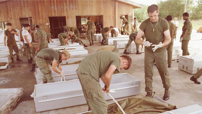 US military personnel place bodies in coffins at the airport in Georgetown, Guyana after 900 members of the Peoples Temple committed suicide in Jonestown. Picture: AP