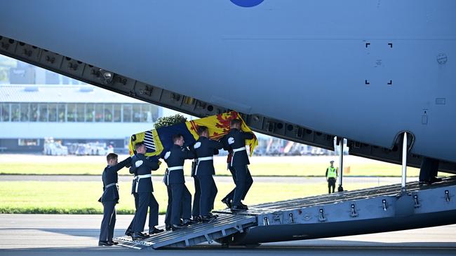 Pallbearers from the Queen's Colour Squadron of the Royal Air Force (RAF) carry the Queen’s coffin, draped in the Royal Standard of Scotland, into a RAF C17 aircraft at Edinburgh airport. Picture: Getty Images.