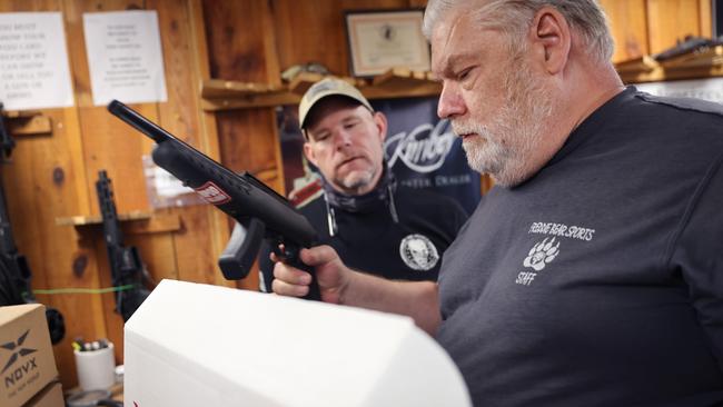 Sports shop owner Fred Lutger looks over a shipment of guns that arrived on Thursday in the Illinois store. Picture: Getty Images/AFP