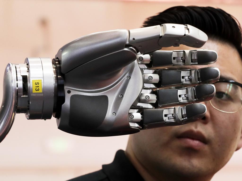 A visitor looks at a robotic hand. China’s government has appealed to Washington to accept its industrial progress after US intelligence officials said Beijing helps to steal and copy foreign technologies. Picture: AP