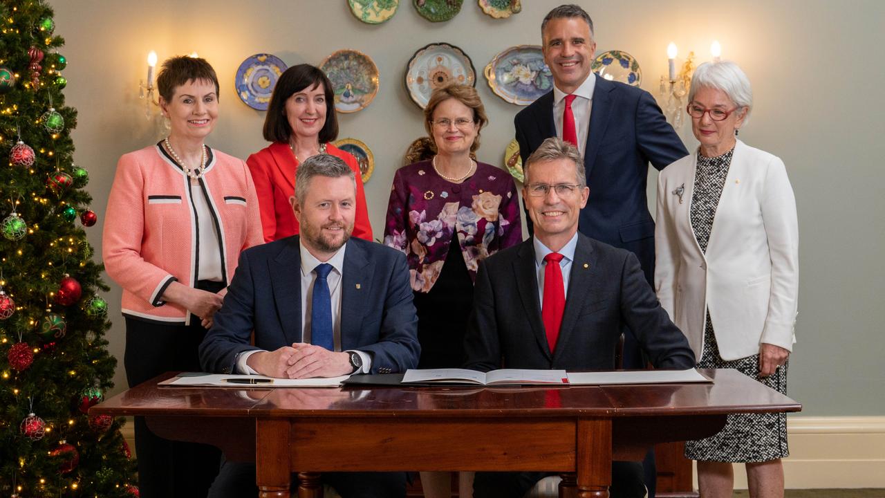 Signing a heads of agreement on December 6, 2022, at Government House are (L-R, back) UniSA chancellor Pauline Carr, Deputy Premier Susan Close, Governor Frances Adamson, Premier Peter Malinauskas, University of Adelaide chancellor Catherine Branson (L-R front) UniSA vice-chancellor David Lloyd and University of Adelaide vice-chancellor Peter Hoj. Picture: Naomi Jellicoe