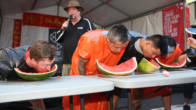 Men partaking in a watermelon eating competition during Lunar New Year festivities at Bankstown City Plaza last year. Picture: Robert Pozo