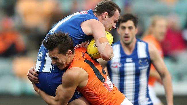 HOBART, AUSTRALIA - JUNE 13: Isaac Cumming of the Giants tackles Jack Mahony of the Kangaroos during the round 13 AFL match between the North Melbourne Kangaroos and the Greater Western Sydney Giants at Blundstone Arena on June 13, 2021 in Hobart, Australia. (Photo by Mark Metcalfe/AFL Photos/via Getty Images)