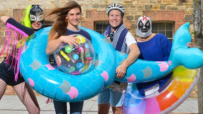 Port Adelaide Enfield Mayor Claire Boan with performers Incognito, left, and The Director, right, and cycling fan Greg Sproule. Picture: AAP / Brenton Edwards