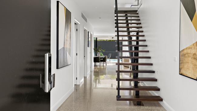 The floating staircase greets you on entry.