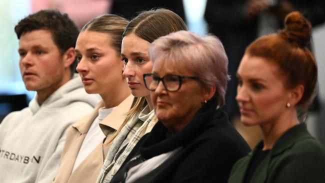 Damien Hardwick’s children, mum Pam, and partner Alexandra Crow, watch on as he speaks to the media following his resignation. Picture: Getty Images