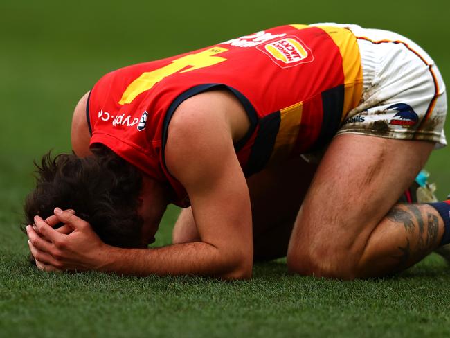 MELBOURNE, AUSTRALIA - JULY 23: Lachlan Murphy of the Crows goes to ground after a heavy hit during the round 19 AFL match between Melbourne Demons and Adelaide Crows at Melbourne Cricket Ground on July 23, 2023 in Melbourne, Australia. (Photo by Graham Denholm/AFL Photos via Getty Images)