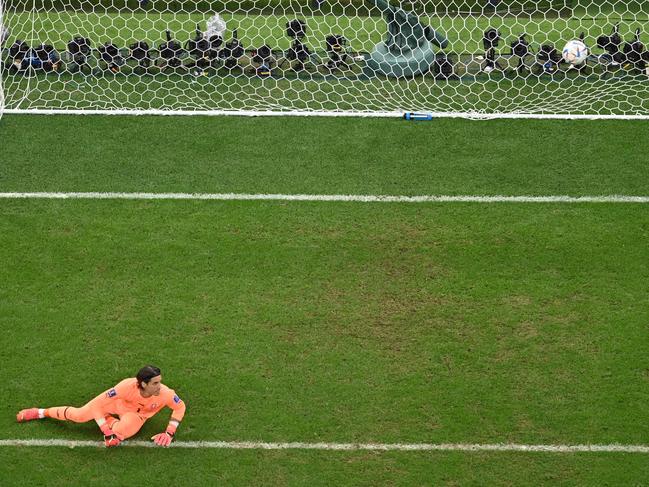 Switzerland's goalkeeper Yann Sommer looks at the ball after failing to stop a goal scored by Portugal's forward Cristiano Ronaldo that will later be disallowed due to an off-side position.