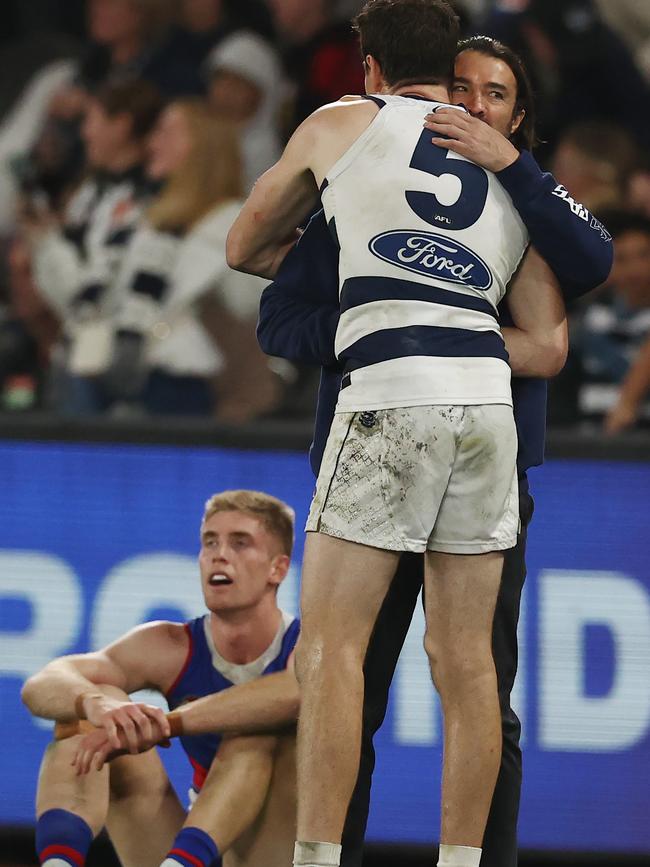 Geelong coach Chris Scott embraces Jeremy Cameron as Bulldogs ruckman Tim English laments another recent loss. Picture: Michael Klein.