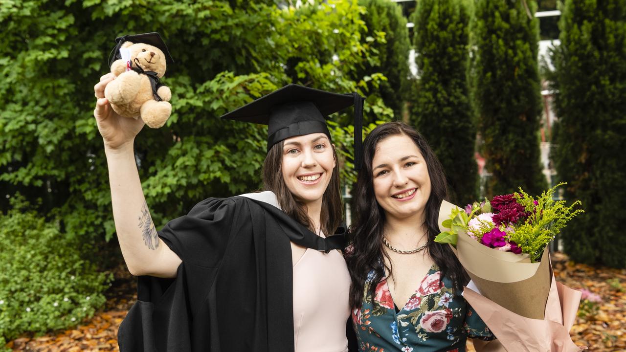 Bachelor of Business graduate Shenee McKenzie celebrates with Krystal Armstrong-Waters at the UniSQ graduation ceremony at Empire Theatres, Tuesday, December 13, 2022. Picture: Kevin Farmer