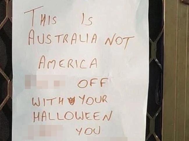 A warning has been issued to hopeful trick or treaters via a note held up by a peg on a screen door. Picture: X.