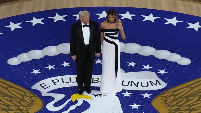 First Lady Melania Trump waves as she stands with President Donald Trump before they dance at the Commander in Chief Ball. Picture: AP