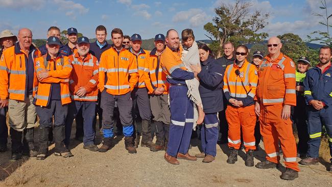 Robert (Bob) Wright this morning with his mum and dad and the search team who helped find the seven-year-old at Lebrina in northern Tasmania. Picture: TASMANIA POLICE 