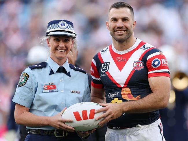 NSW Police Inspector Amy Scott hands James Tedesco the match ball. Picture: Cameron Spencer/Getty Images