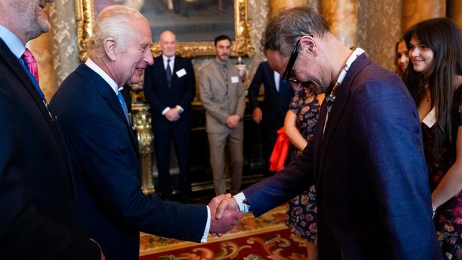 King Charles greets artist Jonathan Yeo at the unveiling of the portrait.