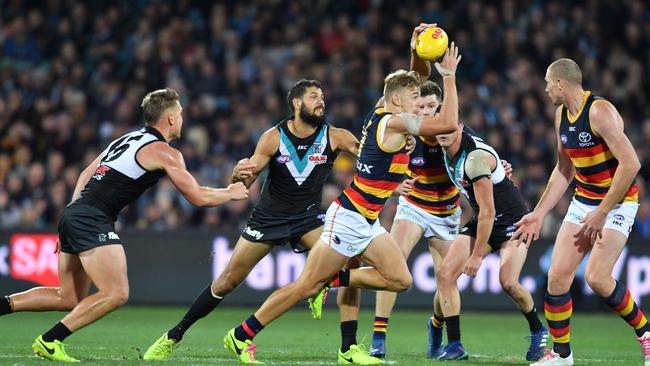 Hugh Greenwood breaks away from a pack of Power players during Showdown 44. AAP Image/David Mariuz