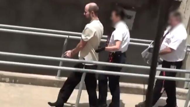 Christopher Lloyd George, is taken into Adelaide Magistrates Court last Thursday. Picture: 10 News First.