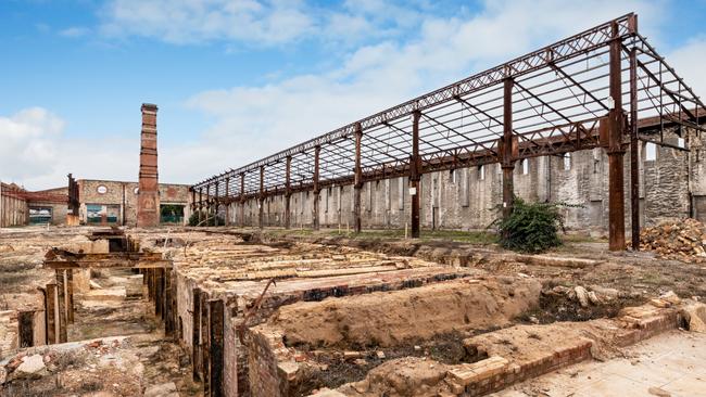 Heritage structures at the former Brompton gasworks site, including the Retort House, its chimney and the bluestone wall on Chief St.