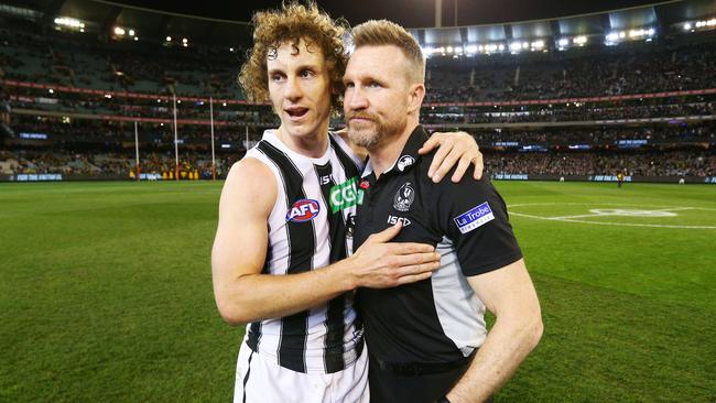 Mayne celebrates the Pies’ preliminary final win over Richmond with a cuddle from coach Nathan Buckley. Picture: AFL Media/Getty Images