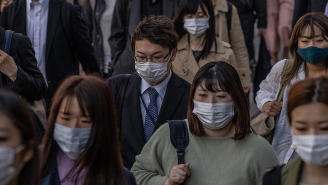 People wearing face masks walk to work in Tokyo. Picture:Getty Images