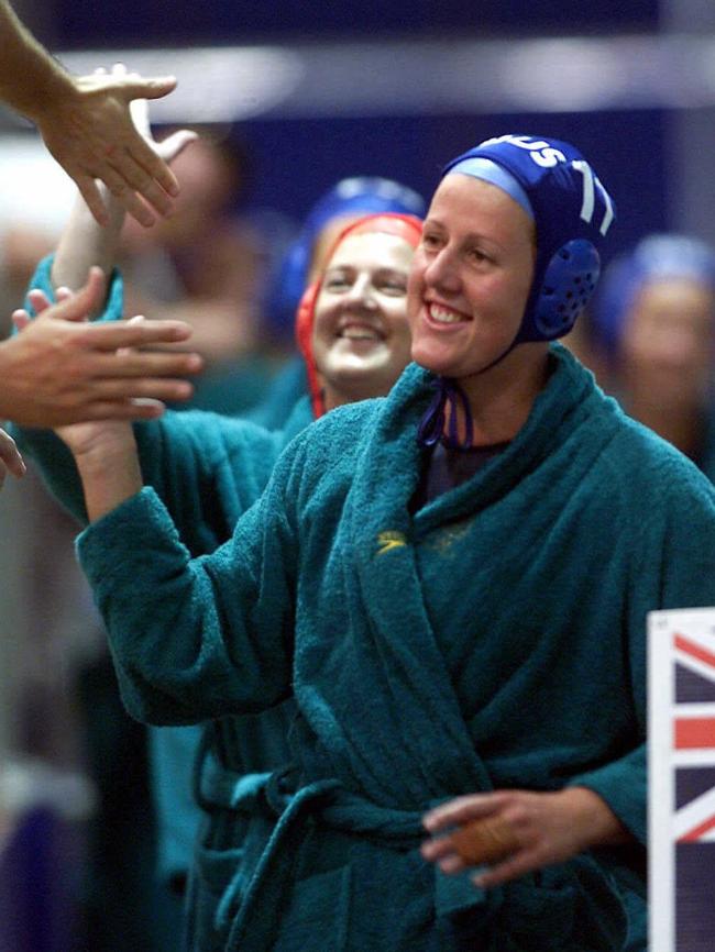 Australia's captain Bridgette Gusterson (now Ireland) gives high fives to the crowd after her team’s win over Canada in the women's water polo at the 2000 Olympic Games in Sydney.